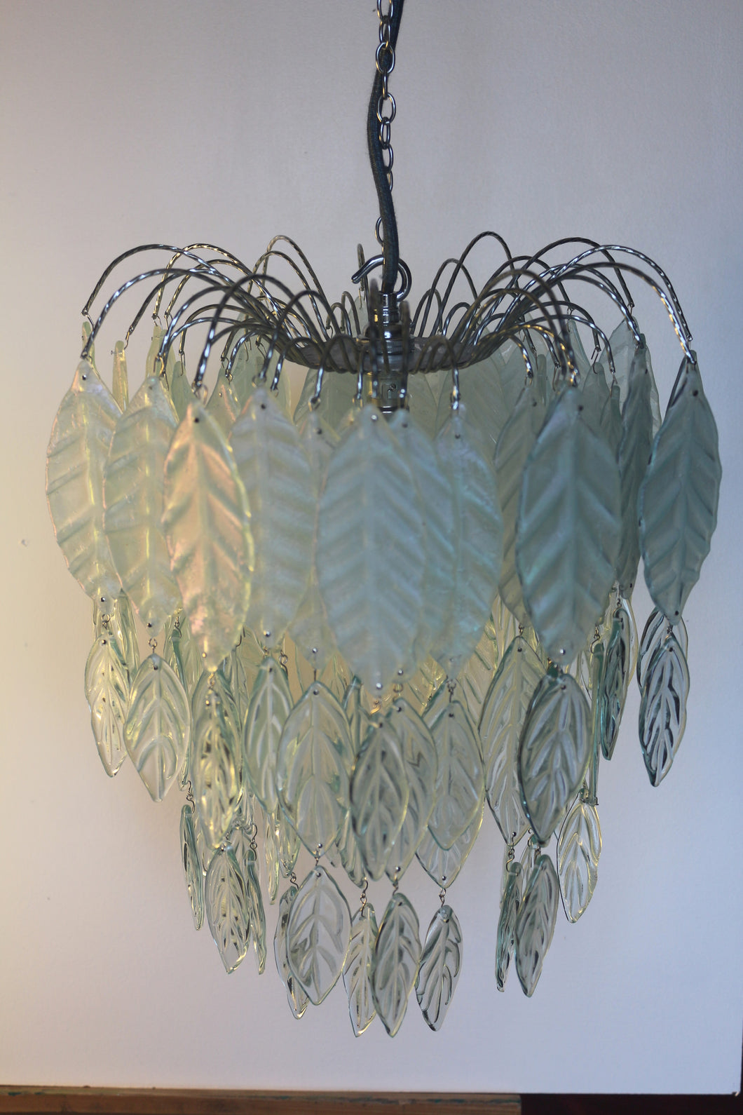 Original Bespoke botanical Chandelier. leaves cascade from 48 branches. These unique glass leaves are created from Recycled glass.